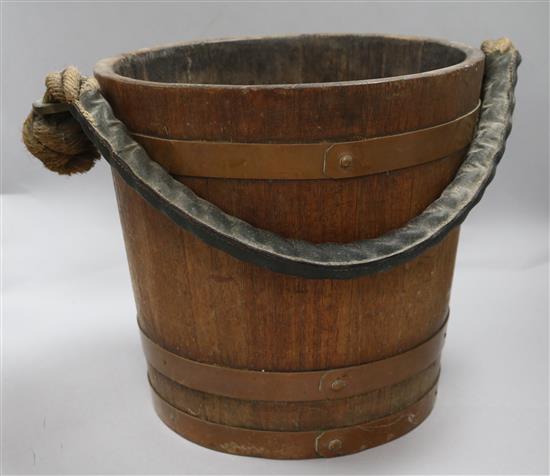 A wooden bucket bearing a coat of arms